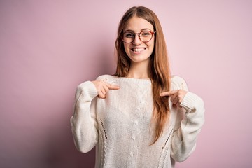 Young beautiful redhead woman wearing casual sweater and glasses over pink background looking...