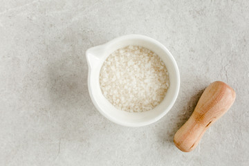 Spa skincare concept. Natural/Organic spa cosmetics products, sea salt on gray marble table from above. Spa background with a space for a text, flat lay, top view.