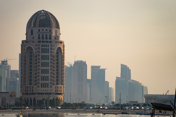 Naklejka premium Doha, Qatar, cityscape of modern but still oldschool buildings during sunset