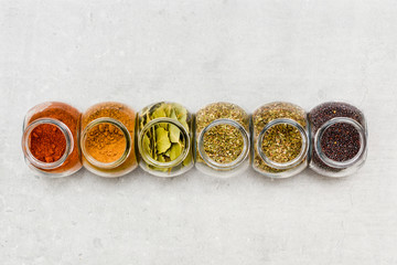 A selection of herbs and spices for adding flavour to food when  cooking on a kitchen worktop at high angle