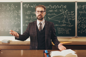 University math lecture held by an intelligent handsome bearded academic