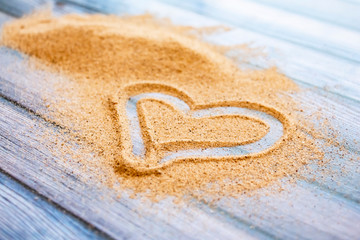 romantic concept of a heart in the sand