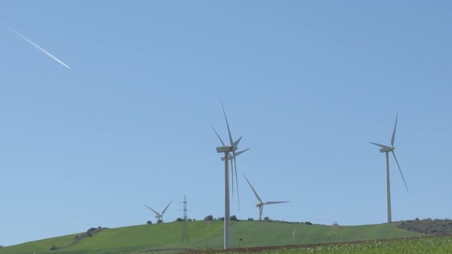 Wind turbines of renewable energy moving a sunny day