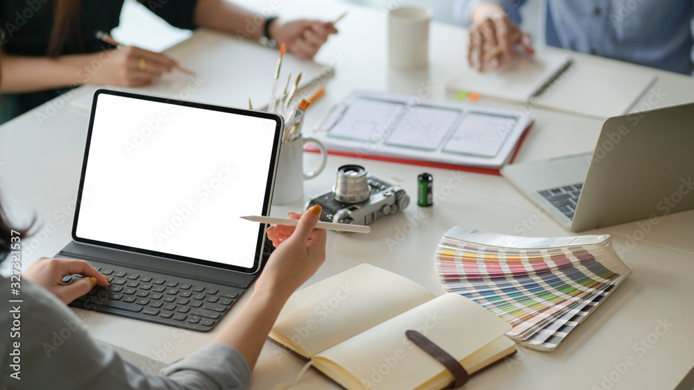 Wall mural a team of professional designers are working with smartphone and laptops to design applications.