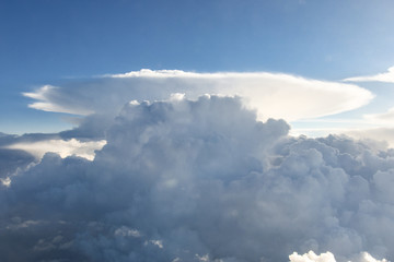 clouds and blue sky background during a commercial flight.