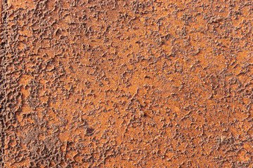 Wet sand on red paving stone after the rain. Abstract red brown background