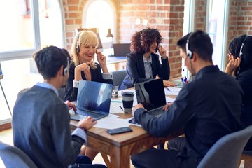Group of call center workers smiling happy and confident. Working together with smile on face using headset at the office.