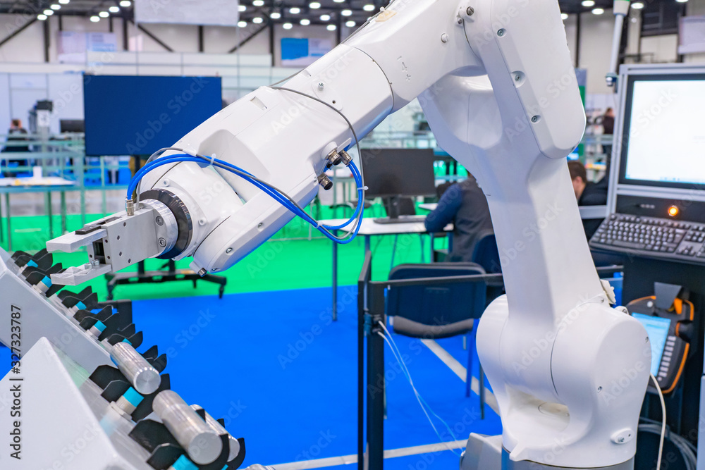 Poster robot hand on the background of a technical laboratory. demonstration of the industrial manipulator.