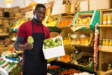 Salesman offering artichokes