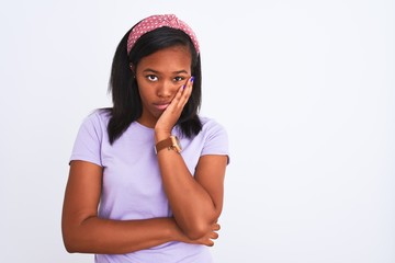 Beautiful young african american woman wearing a diadem over isolated background thinking looking tired and bored with depression problems with crossed arms.