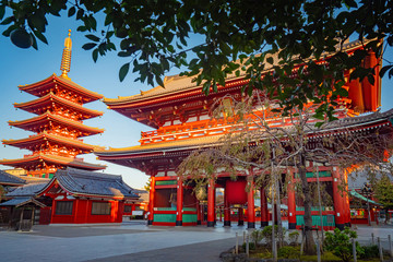 Japan. Tokyo Attractions. Asakusa temple on a background of tree leaves. Asakusa red pagoda. Walk in the Asakusa area. Streets Of Tokyo. Buddhist temples in Japan. Sensoji. Tourism in East Asia