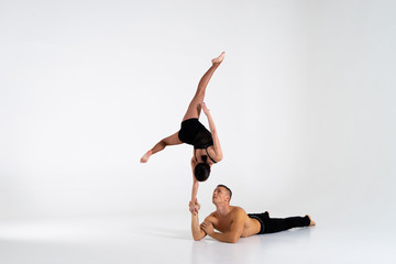 Duo Of Acrobats Showing hand to hand Trick, Isolated On White