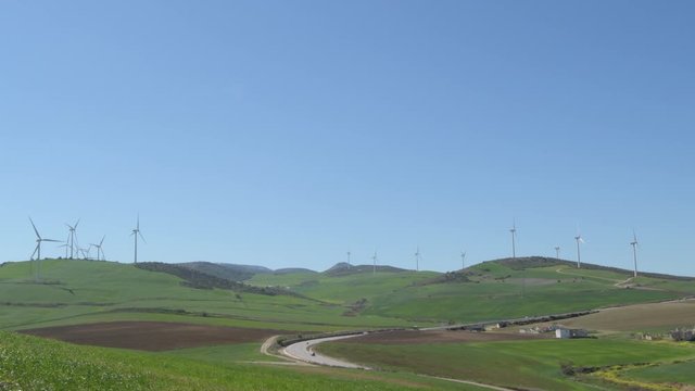 Landscape of wind turbines moving the blades a sunny day with blue sky