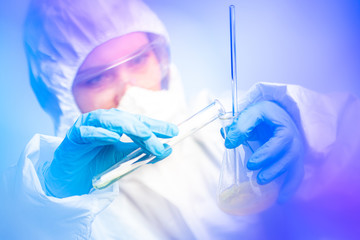 A chemist connects chemical liquids. A potentially dangerous chemical experiment. Analysis of substances from the contamination site. Dangerous experiments. Ecologist at work.