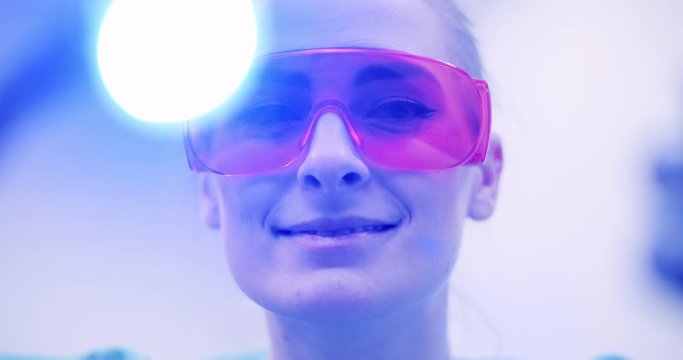 dentist using UV hardener during surgey at healthcare clinic