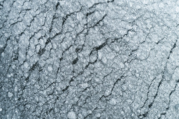 Aerial view on the abstract ice pattern on the surface of the lake. Light bright white ice.