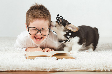Teen boy and Corgi puppy with glasses