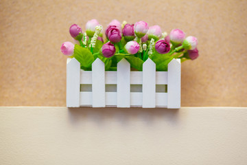 Home decoration. Artificial beautiful decorative flowers in the original pot. Copy space. Space for text.