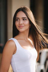 Fototapeta premium Portrait of beautiful brunette outside. Attractive young woman