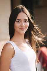 Fototapeta premium Portrait of beautiful brunette outside. Attractive young woman