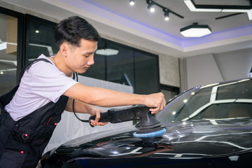 Car cleaning auto service : the man cleaning and polishes. car detailing concepts. Selective focused