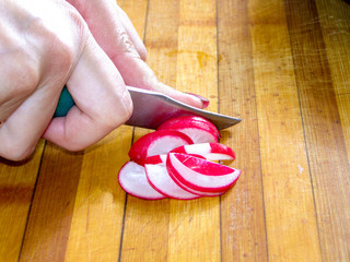 The process of preparing vegetable salad with feta cheese.