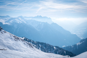 Fototapeta na wymiar Morning mountain landscape at a ski resort Campitello di Fassa Italy. Sun and haze in the mountains