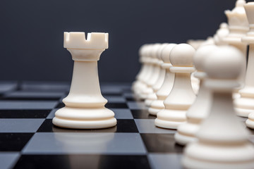 Chess pieces, rook on a chessboard, game. The concept of confrontation, career, competition, startup, battle of brains.