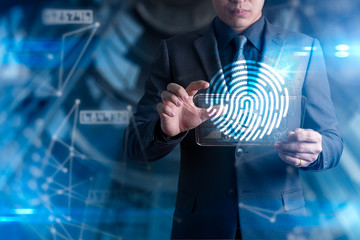 The abstract image of the businessman use a thumb scanning overlay with futuristic hologram. the concept of fingerprint, biometric, information technology and cyber security.