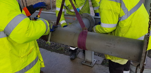 riggers move the pipe with two chain blocks and attach the flange with bolts