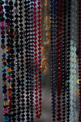 beads hang from multi-colored pebbles