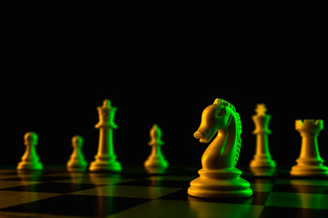 Chess pieces on a chessboard, knight move, game. The concept of confrontation, career, competition, startup.