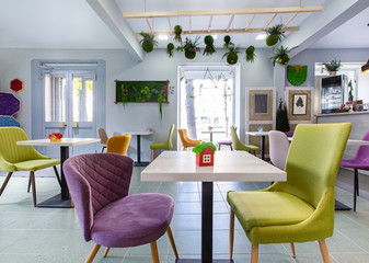 Bright interior of modern cafe decorated with plants