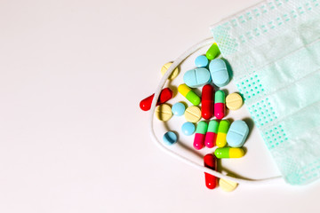 Colorful medicine with green mask on white background. Corona virus concept.