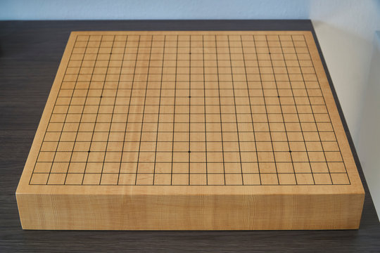 Empty wooden goban on the desk, front view