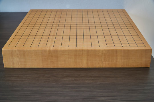 Empty wooden goban on the desk, front view with the table surface