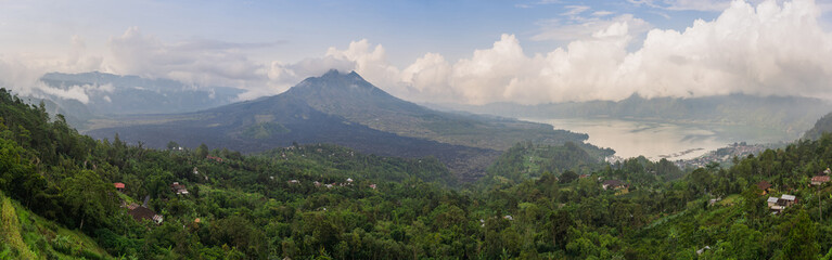 Fototapeta na wymiar Wide panorama of Mount Batur or Gunung Batur, an active volcano located at the center of caldera and Mount Agung which dominates the surrounding area on the island of Bali, Indonesia