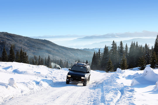 Modern car on snowy country road. Winter vacation