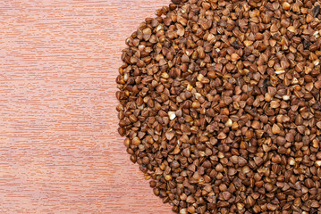 raw buckwheat on a wooden background