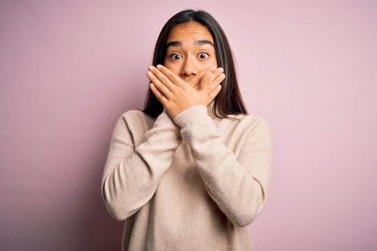 Young beautiful asian woman wearing casual turtleneck sweater over pink background shocked covering mouth with hands for mistake. Secret concept.