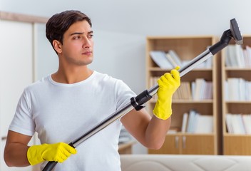 Man husband cleaning the house helping wife