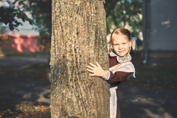 little girl hugged a tree. care concept.
