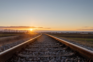 Fototapeta na wymiar Gleise der Pulkautalbahn bei Untermarkersdorf während dem Sonnenuntergang