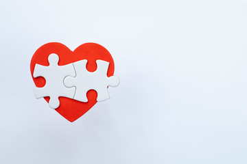Red heart and puzzle pieces.