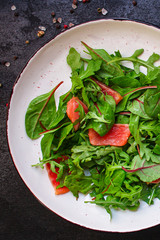 healthy salad leaves mix, salmon or tuna (delicious snack) pescatarian, keto or paleo diet menu concept. food background. top view. copy space