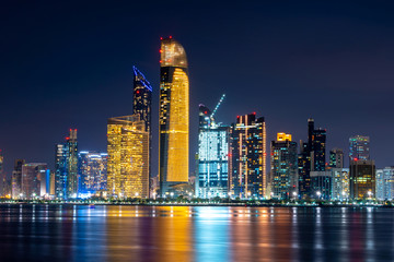 Night view of Abu Dhabi financial district skyline. Luxury lifestyle hotels and business. United Arab Emirates. 