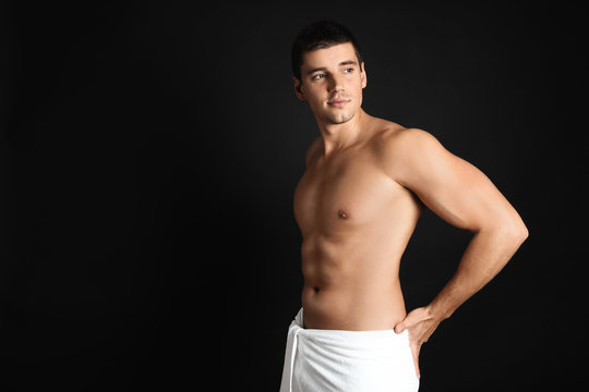 Man with sexy body on black background. Space for text