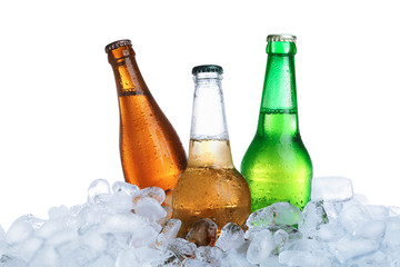 Ice cubes and different bottles on white background