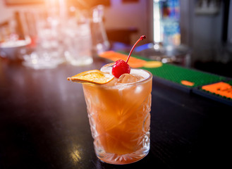Non alcoholic cocktail with lemon and oranges at wooden bar counter. Restaurant.