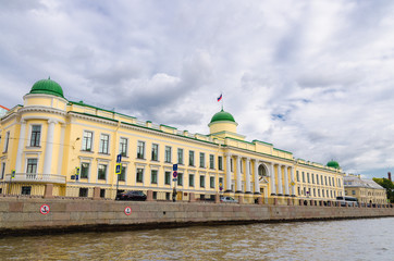 Leningrad Regional Court building on promenade of Fontanka river, blue dramatic sky background, Saint Petersburg Leningrad city, Russia